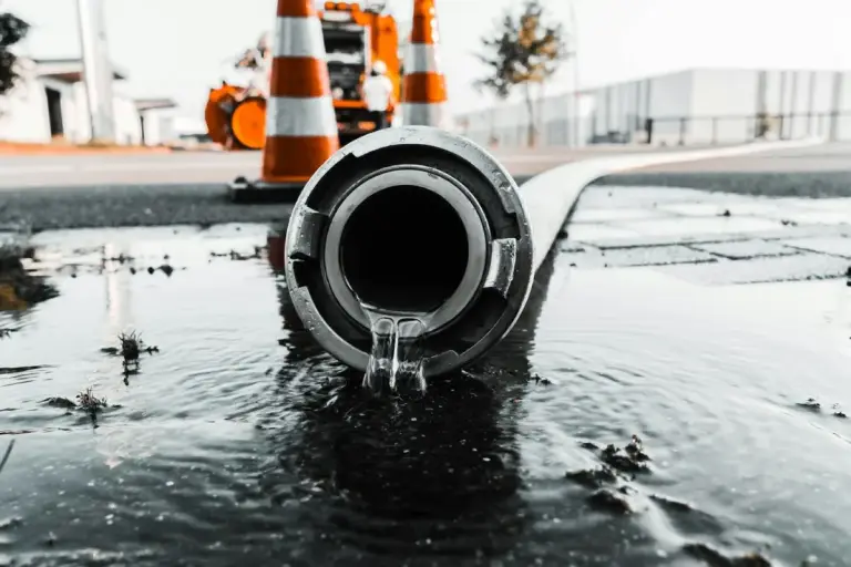Water flowing from a pipe onto pavement