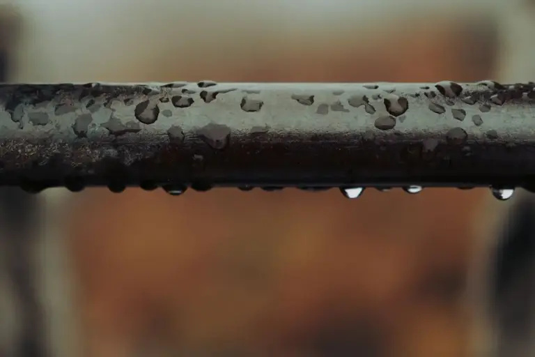A cold pipe covered in water droplets