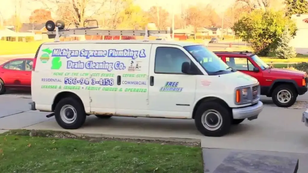 The white Michigan Supreme Plumbing & Drain Cleaning van parked on a residential street